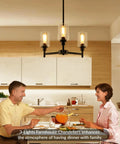 Industrial Glass Cylinder Pendant Chandelier in Black, 6 Light Farmhouse Vibe over a dining table with people eating.