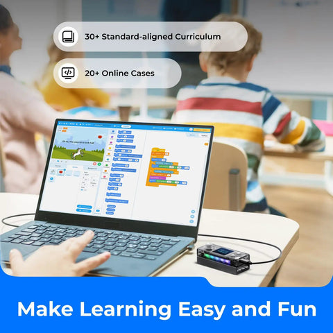 CyberPi Project Based Coding Kit For Kids Ages Eight To Twelve With Hands On STEM Projects Including An Auto Driving Car An Oscillating Fan And A Smart Trash Bin Made To Spark Creative Problem Solving And Real World Tech Skills. Laptop with coding app and CyberPi device on classroom desk