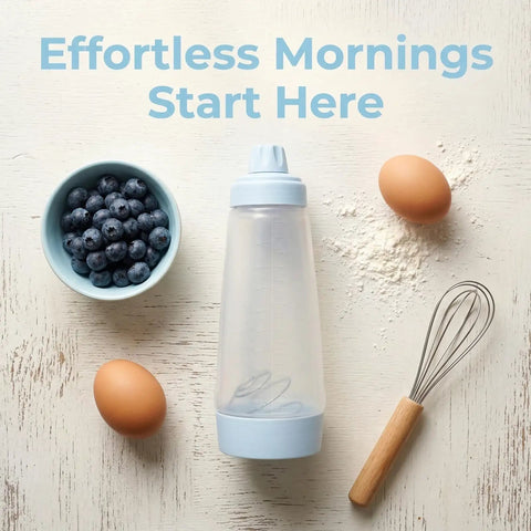 All In One Pancake Batter Dispenser with BlenderBall next to whisk, eggs, flour, and blueberries