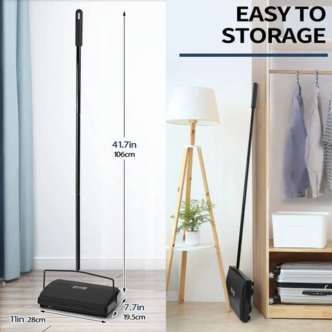 Manual Carpet Floor Sweeper With Dual Horsehair Brush Roll Quiet Non Electric Push Broom For Snagging Pet Hair And Lint No Sweat Home Cleaning Gear Black standing next to shelving.