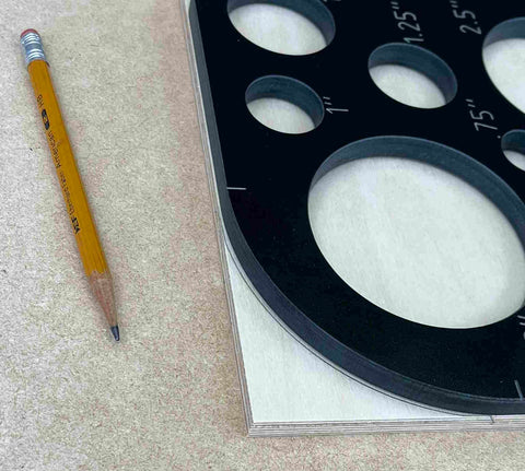 Top Shelf 11 Piece Phenolic Corner Radius And Circle Template Set showing circle templates on wood with a pencil for woodworking.