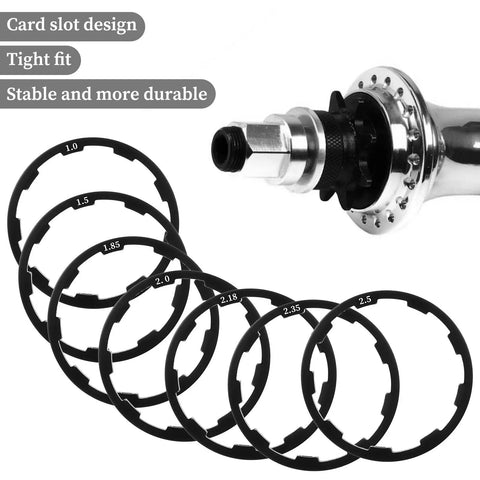 Eight Piece Bike Headset Spacers Set For Road And Mountain Bikes Aluminum Alloy Washers With Seven Sizes 1.0 1.5 1.85 2.0 2.18 2.35 2.5 mm displayed with hub
