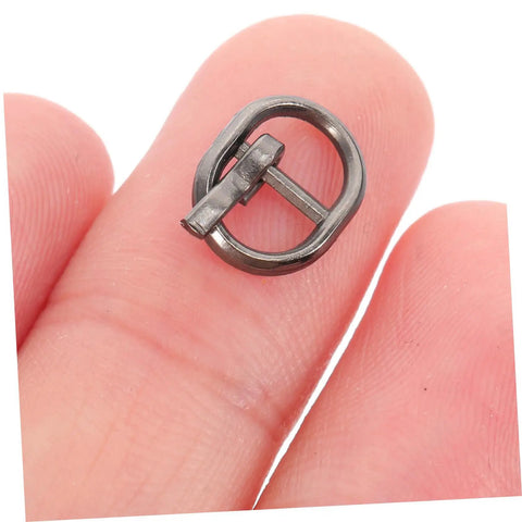 Close-up of a silver gunmetal buckle from the Mini Alloy Belt Buckles Set For Doll Clothes And Tiny Belts, 150 Pcs Small Single Prong Fasteners.