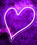 Heart Shape LED Neon Light Sign 13.4 Inch Wall Hanging Neon Vibe Decor with purple glow against floral background.