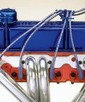 Red Four Hole Spark Plug Wire Loom Kit with Chrome Brackets installed on engine, showcasing neat wire arrangement.