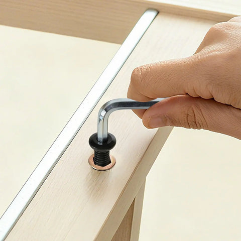 Close-up of installing a Woodworking Threaded Inserts and Bolts Kit For DIY Furniture Repair, including hex wrench usage.