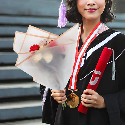 Graduate holding a bouquet wrapped in Floral Bouquet Wrapping Paper Waterproof Protective Wrap Paper 20 Sheets Cuttable For Flowers and Bouquets