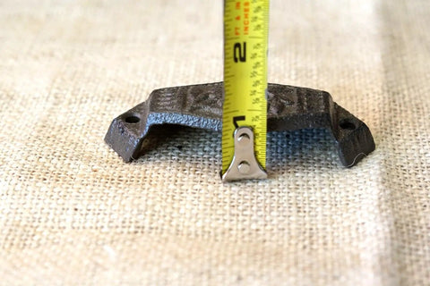 Top Notch Vintage Cast Iron Cup Pulls for Dresser Cabinet Bin Hardware measuring 4 inches on burlap background.