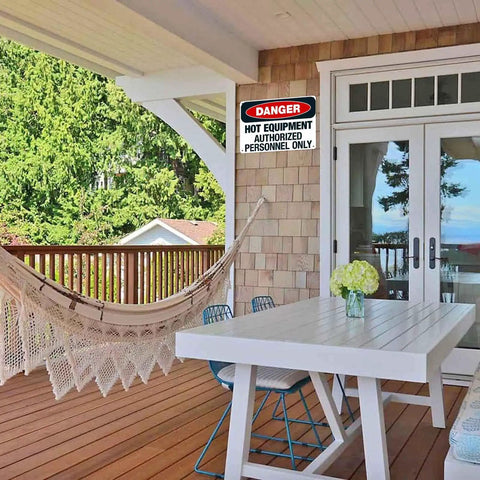 Danger Hot Equipment Warning Sign Authorized Personnel Only 8x12 Inch Aluminum Metal on porch wall with hammock and table.