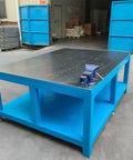 Rock Solid No Nonsense Heavy Duty Workbench For Welding And Metal Fabrication With 8mm Thickened Steel Plate, blue frame, flat top, and vice.