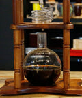 Huge 3 Liter Cold Brew Coffee Maker Serves 25 Cups Of Smooth Iced Tea And Bold Drip Coffee With Zero Hassle Setup showing glass jar and wooden stand.