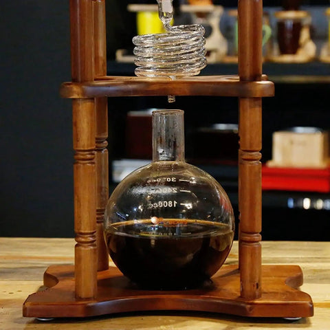Huge 3 Liter Cold Brew Coffee Maker Serves 25 Cups Of Smooth Iced Tea And Bold Drip Coffee With Zero Hassle Setup showing glass jar and wooden stand.