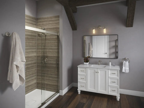 Bathroom with Two Light Wall Sconce In Vibrant Brushed Nickel From The Artifacts Collection above white vanity unit.