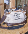 Tough As Nails 14 Inch Tool Bag With Detachable Shoulder Strap, 10 Interior Pockets For Hand Tool Organization on wooden workbench