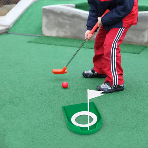 Child using Two Pack Golf Putting Cup With Flag For Indoor Outdoor Practice, Putt Hole Training Aids, on green surface