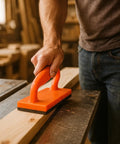 Hand using Pro Grade 5 Piece Woodworking Table Saw Safety Push Block Set with long orange push block for saw table