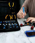 Person using All In One Tool Kit For Remote Control Cars Boats Drones Quadcopters And Helicopters with screwdrivers and pliers