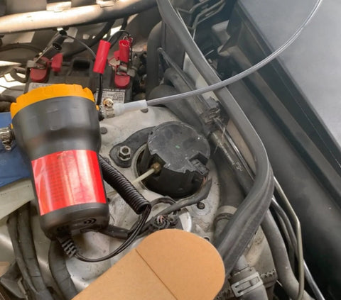Portable 12V 60W Oil Extractor Pump For Fluid Changes in use for a car engine oil transfer, electric, compact design with battery clips.