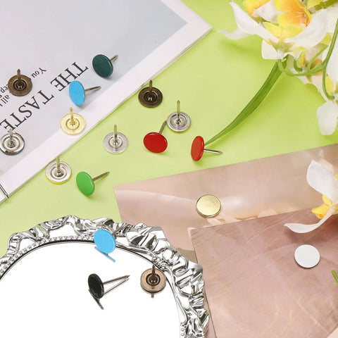 Grab and Go Upholstery Tacks Kit: 150 Pcs Decorative Furniture Nails Push Pins in various colors on a green surface.