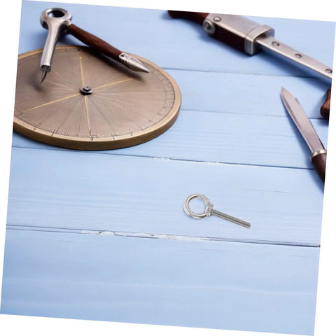 Top Rated Rust Proof Stainless Steel M10x60 Eye Bolt with nut on a blue wooden surface, used for heavy rigging.