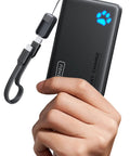 Hand holding a Compact 10000mAh Power Bank Featuring 45W Fast Charging Portable Charger with USB cable attached.