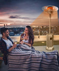 Couple on patio warmed by Three Panel Patio Heater Reflector Shield For Outdoor Heaters, Large Heat Deflector That Extends Range