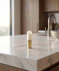 Brass Shelf Support Pins One Quarter Inch With Rubber Covers on a marble countertop