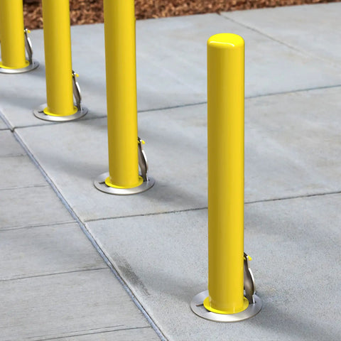 4X36 Inch Badass Removable Bollard With Embedment Sleeve Powder Coated Yellow Carbon Steel installed on concrete surface.