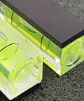 Close-up of two acrylic bubble levels from the Six Pack Mini Magnetic Bubble Level Kit with neon vials for precise measurements.