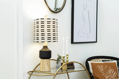 Natural Wood And Black Ceramic Table Lamp With Linen Mudcloth Shade, Rotary Switch, 60W Max, in modern living room setting.