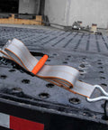 Beefy Ratchet Straps With Wire Hooks 2 Inch By 15 Foot 4 Pack Silver Series on a trailer with black steel surface