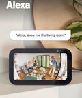 Sleek 360 Degree Pan Tilt Indoor Security Camera With Crisp Hd Video And Two Way Talk For Keeping Tabs On Your Space Plus Instant Smart App Alerts And Clean White Case For A Solid Setup You Know You Need Right Now in a living room setting monitoring a social interaction.