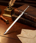 Sword Letter Opener with Ergonomic Handle and Precision Blade on desk with books, envelope slitter, ancient sword design in silver