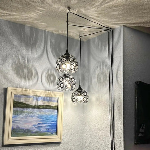 Black Crystal Plug In Chandelier With 13.12ft Cord And On And Off Switch Easy Setup Hanging Pendant Light For Kitchen Island Bedroom Reading Nook 360 Degree Lighting No Assembly Required hanging in corner casting intricate patterns on ceiling and wall.