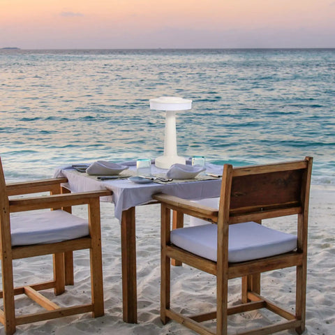 Beach setting with Two Pack Nightstand Lamps With Sensor Control And USB Charging Portable Bedside Lights for Kids on a table.