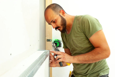 Person using Two Pack 1.5 Inch By 1.5 Inch Aluminum Angle 6063 T5 Built Tough Precision Extruded Architectural Trim for installation