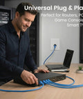 Man connecting Cat6 Ethernet Cable Pack 20 Count 10 Ft Patch Cables with Snagless Gold Plated RJ45 Connectors in a home office
