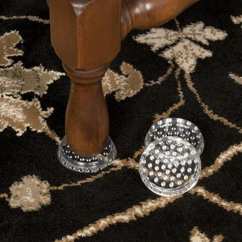 4 Inch Round Spiked Caster Cups For Carpet Protection And Furniture Stability Anti Dent Base Reduces Indentation And Prevents Sliding Clear Caster Cups For Tables Beds Sofas And Chairs Set Of Four, shown in use on carpeted floor with furniture leg for protection and stability.