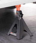 Pair of VEVOR 6-ton jack stands with black base and orange top clamp, adjustable height under vehicle.