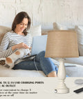 Woman sitting on couch next to Three Way Dimmable Touch Lamps For Bedrooms Set Of 2 With USB Ports And AC Outlet Rustic Resin Nightstand Lamps With Drum Shade Go To Bedside Lighting For Living Rooms And End Tables Includes Two Bulbs.