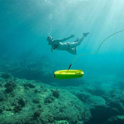 Five Thruster Mini Underwater Drone with 4K HD Camera and 100 Meter Tether exploring ocean depths with diver in view