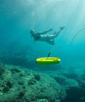 Go Anywhere Five Thruster Mini Underwater Drone With 4K Ultra HD Camera And 100m Tether in sea with snorkeler, yellow