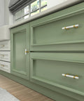 Ten Pack Center Mount Cabinet Knobs And Barrel Drawer Pulls In Matte Black With Gold Accents on green cabinetry.