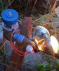 Beast 500W Micro Hydroelectric Turbine Generator for Outdoors setup with glowing bulbs, in a natural setting.