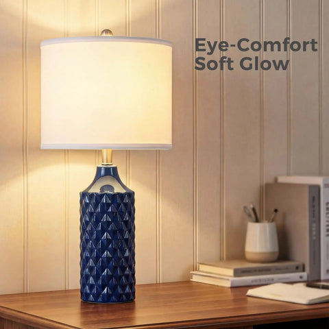 Navy Blue Diamond Texture Modern Ceramic Table Lamp with Soft Glow on Wooden Desk in Bedroom