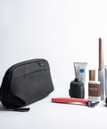 Small Wash Pouch Travel Toiletry Bag Weatherproof With Upright Or Hanging Design beside toiletries on a white surface