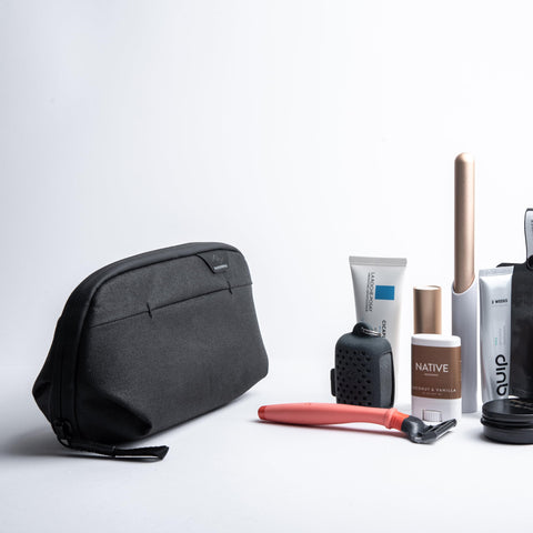 Small Wash Pouch Travel Toiletry Bag Weatherproof With Upright Or Hanging Design beside toiletries on a white surface