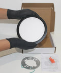 7-Inch LED Pancake Light Surface Mount Dimmable Wet Location Super Slim Fixture Bronze in hand over packaging.