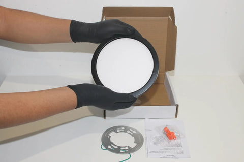 7-Inch LED Pancake Light Surface Mount Dimmable Wet Location Super Slim Fixture Bronze in hand over packaging.