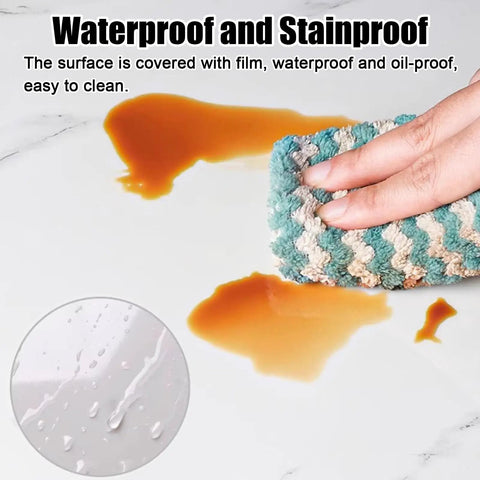 Person cleaning a spill with a cloth on a waterproof surface, showcasing durability of Ultra Smooth White High Gloss Ceiling Tiles Heavy Duty Peel And Stick Sound Muting Pvc Foam Panels For Chill Bedrooms And Nurseries Thick Drop Ceiling Refreshers Quick Snap Install Game Changing Homeowner Hack.
